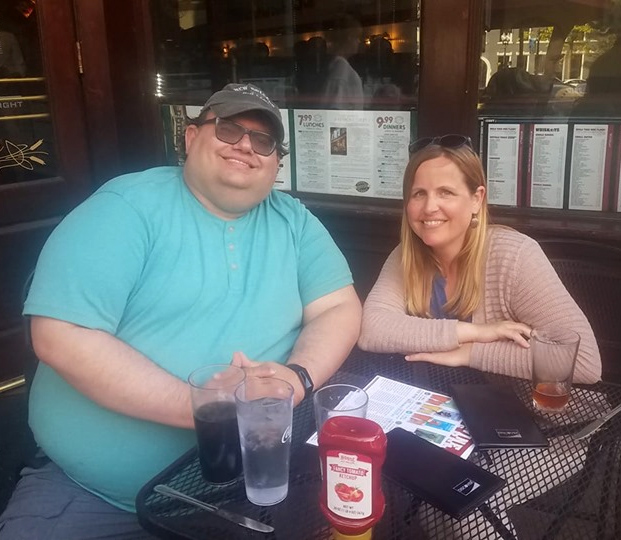 Dr. Doug Kane seated at a restaurant table with Abby Perdue.