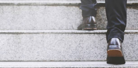 Close up of dress pants and nice shoes walking up steps