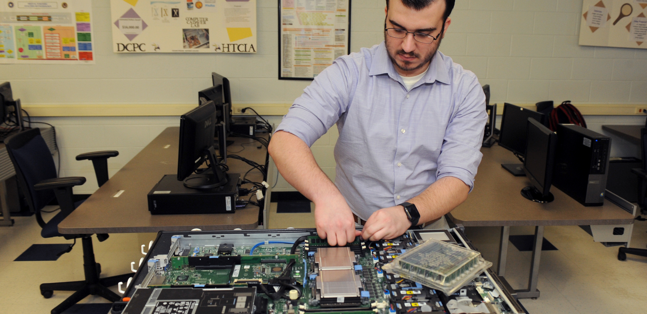 Student working on the inside of a server